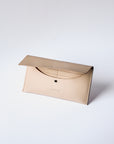 A natural, undyed leather envelope wallet sits against a white background. It has the "Harper" logo heat stamped at the bottom, with the top flap secured by a brass button stud. The top flap is open to show the inner compartment, revealing the stitched cardslots.