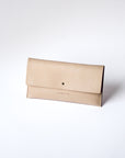 A natural, undyed leather envelope wallet sits against a white background. It has the "Harper" logo heat stamped at the bottom, with the top flap secured by a brass button stud.