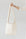 A woman's arm is visible, holding out the strap of a large, soft undyed, natural leather shoulder bag.