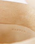 The interior of large, soft undyed leather shoulder bag, showing the inside pocket with stitching and the "Harper" logo.